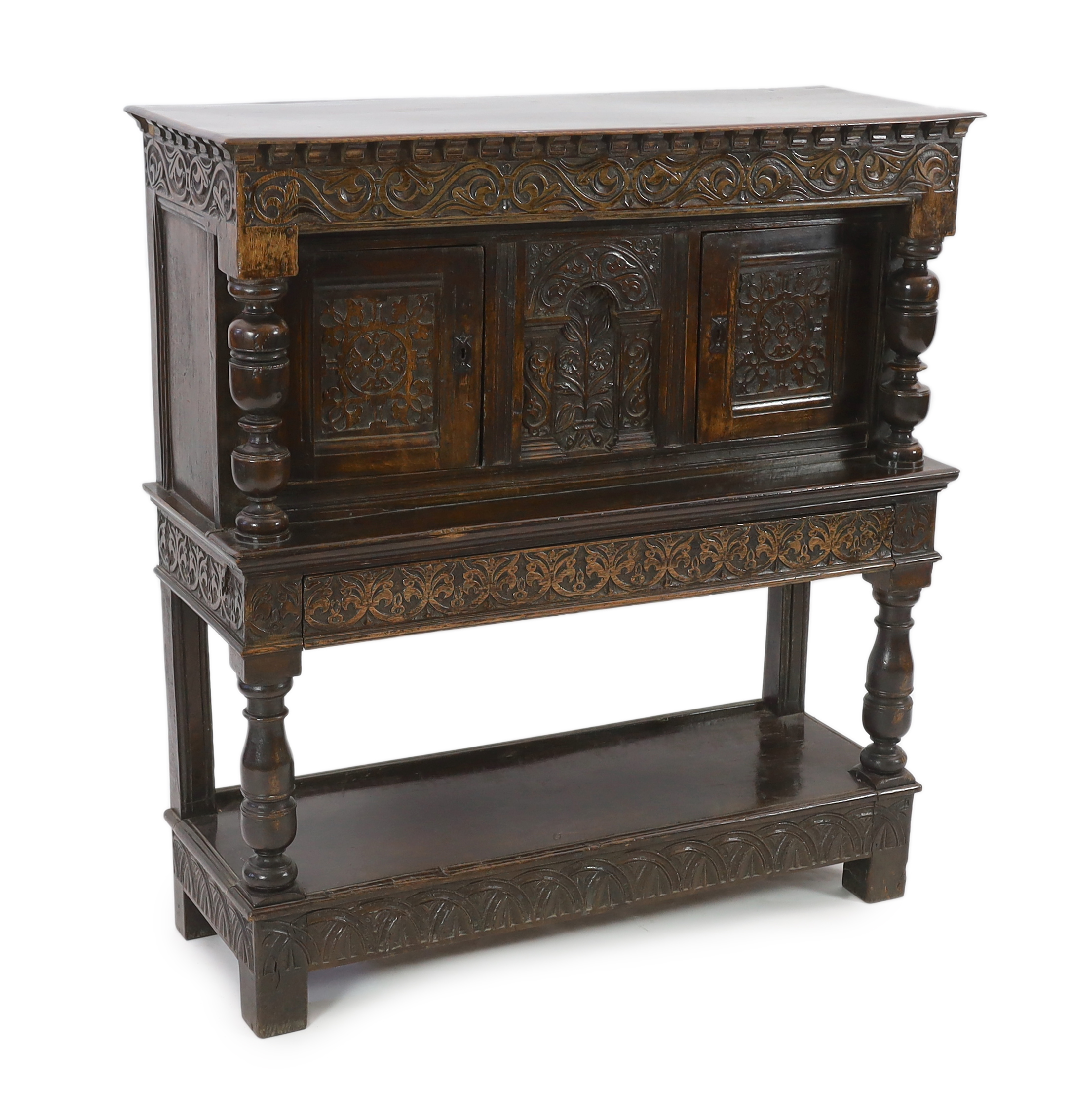 A Charles I carved oak court cupboard